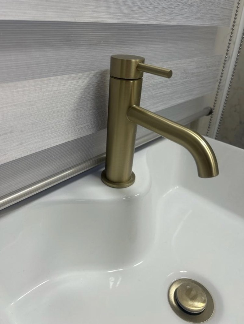 Brushed brass basin tap fitted