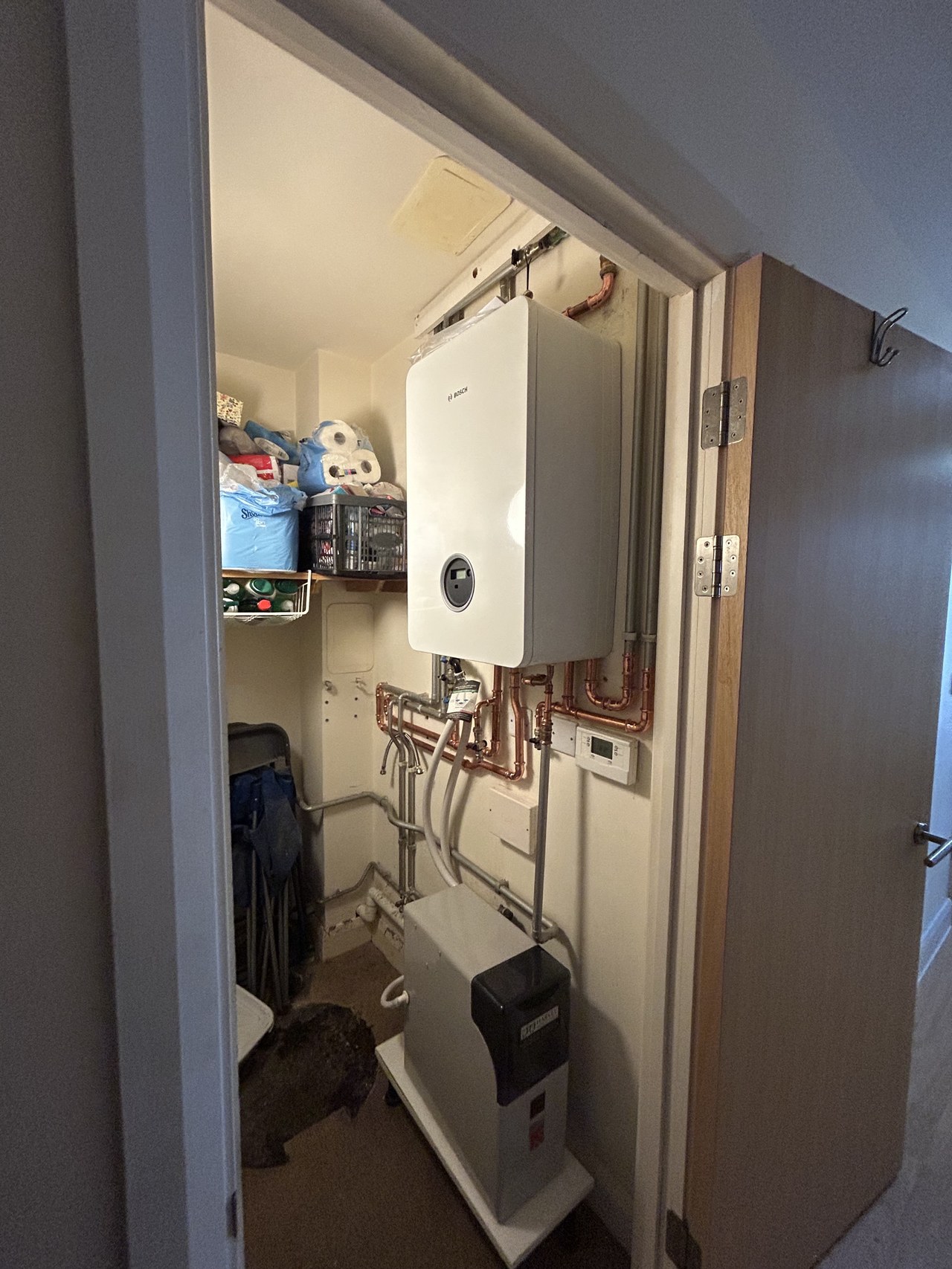 Heating unit alongside a hot water cylinder