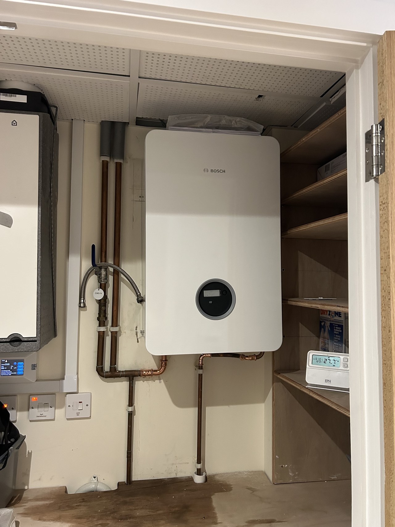 Heating unit in a shelved cupboard