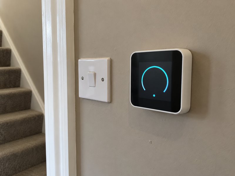 A wall-mounted smart heating thermostat showing the room temperature